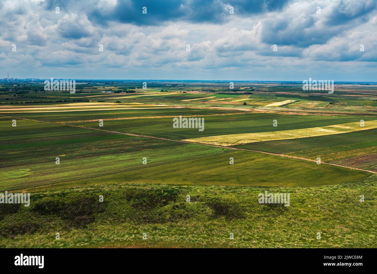 Aerial shot of beautiful countryside landscape with cultivated fields in Banat, geographical region of Vojvodina province in Serbia, drone pov high an Stock Photo