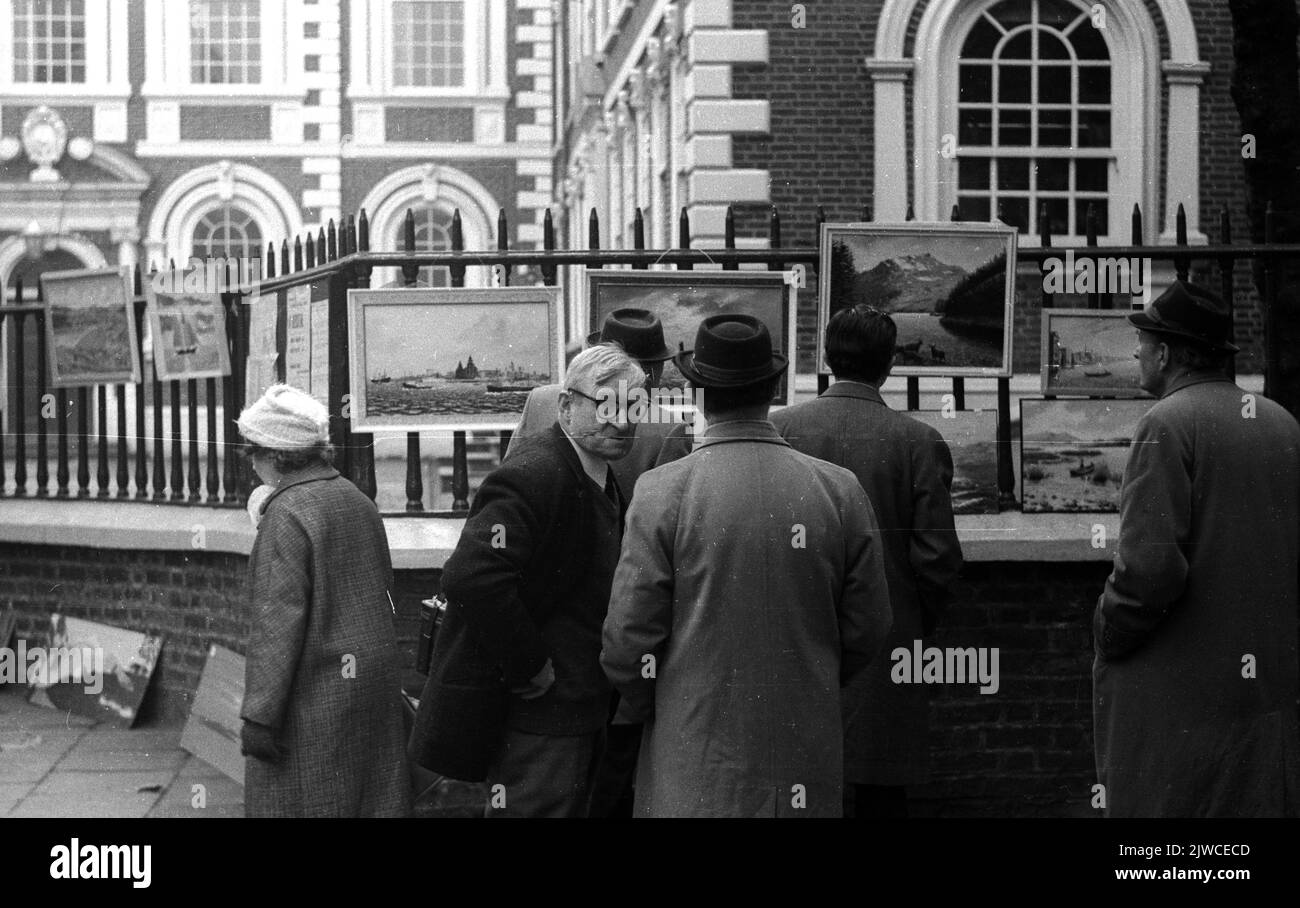 People viewing paintings outside The Bluecoat, Liverpool, UK. 1970 Stock Photo