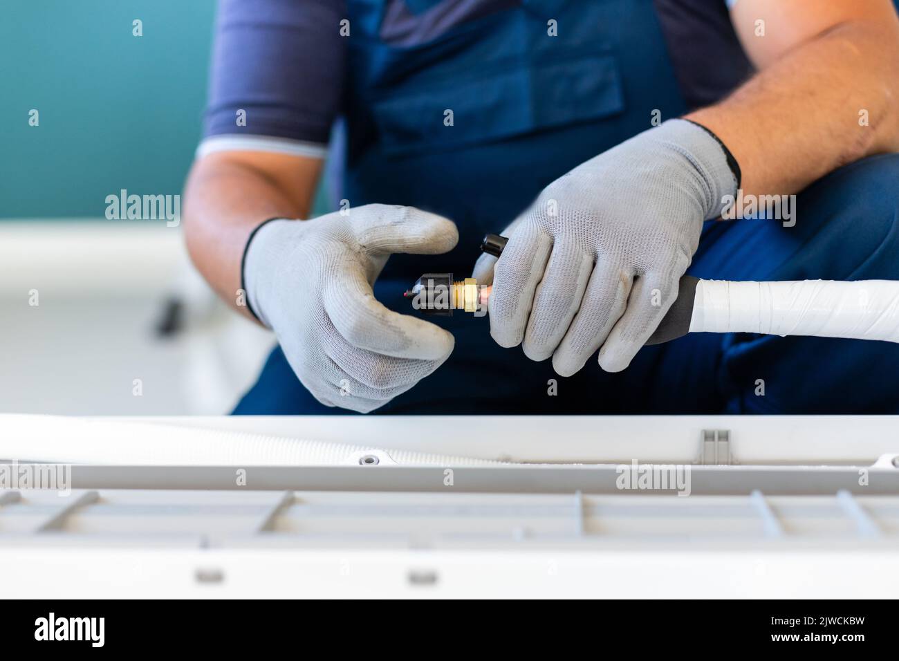 Refrigeration tool. Male technician prepares tools to quickly connect