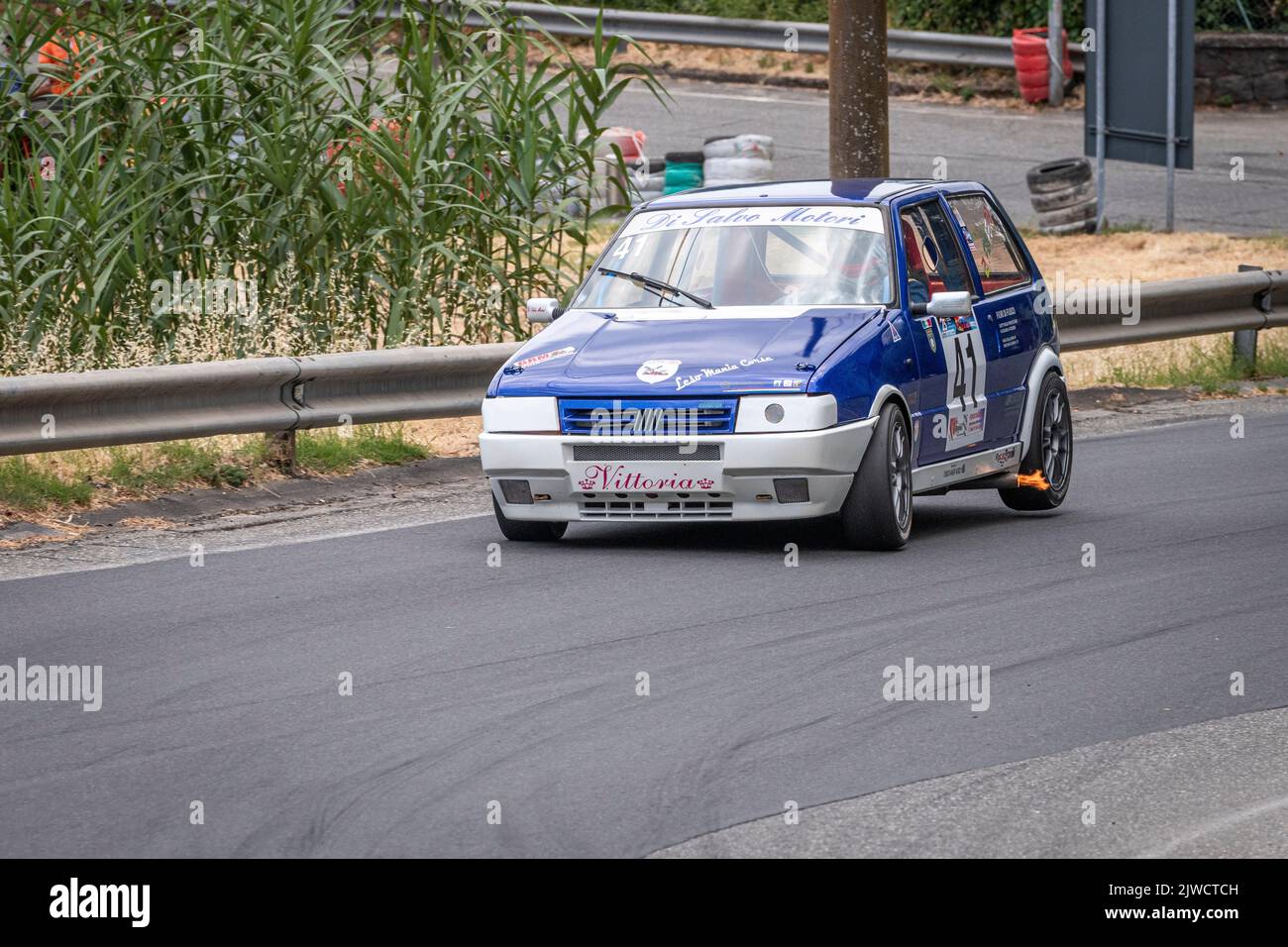 A Fiat Uno T backfiring during the 2022 Giarre-Milo hill climb on Mount Etna, Sicily, Italy Stock Photo