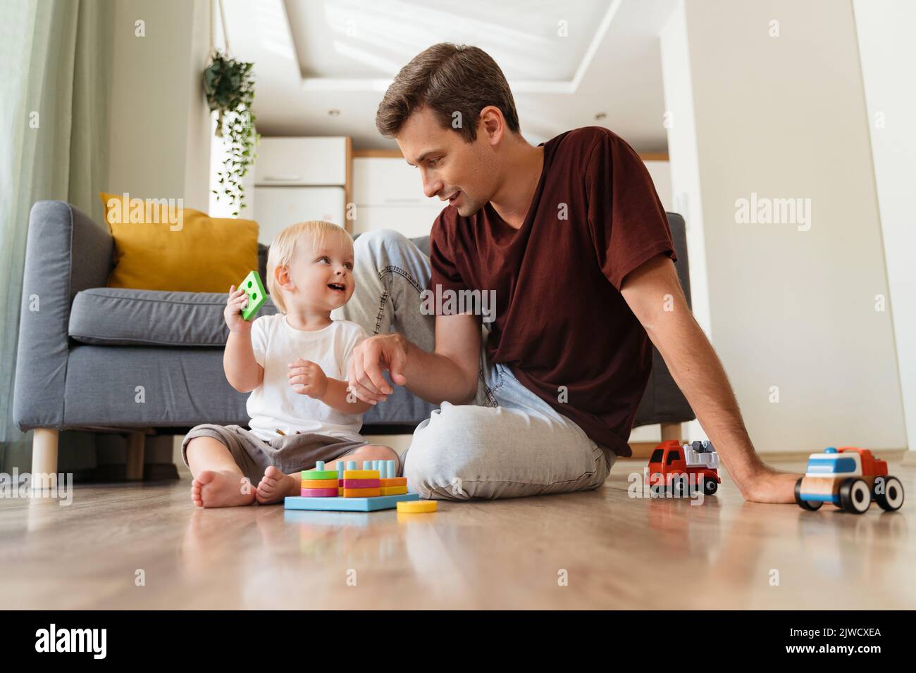 Boy father sitting living room floor hi-res stock photography and images -  Page 2 - Alamy