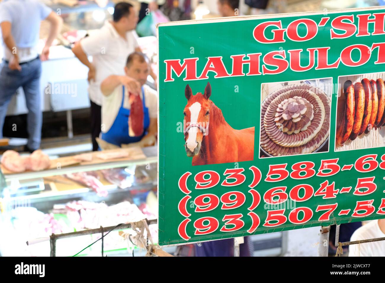 Chorsu Bazaar in Tashkent Uzbekistan - market traders selling horse meat at a butchers stall in August 2022 Stock Photo