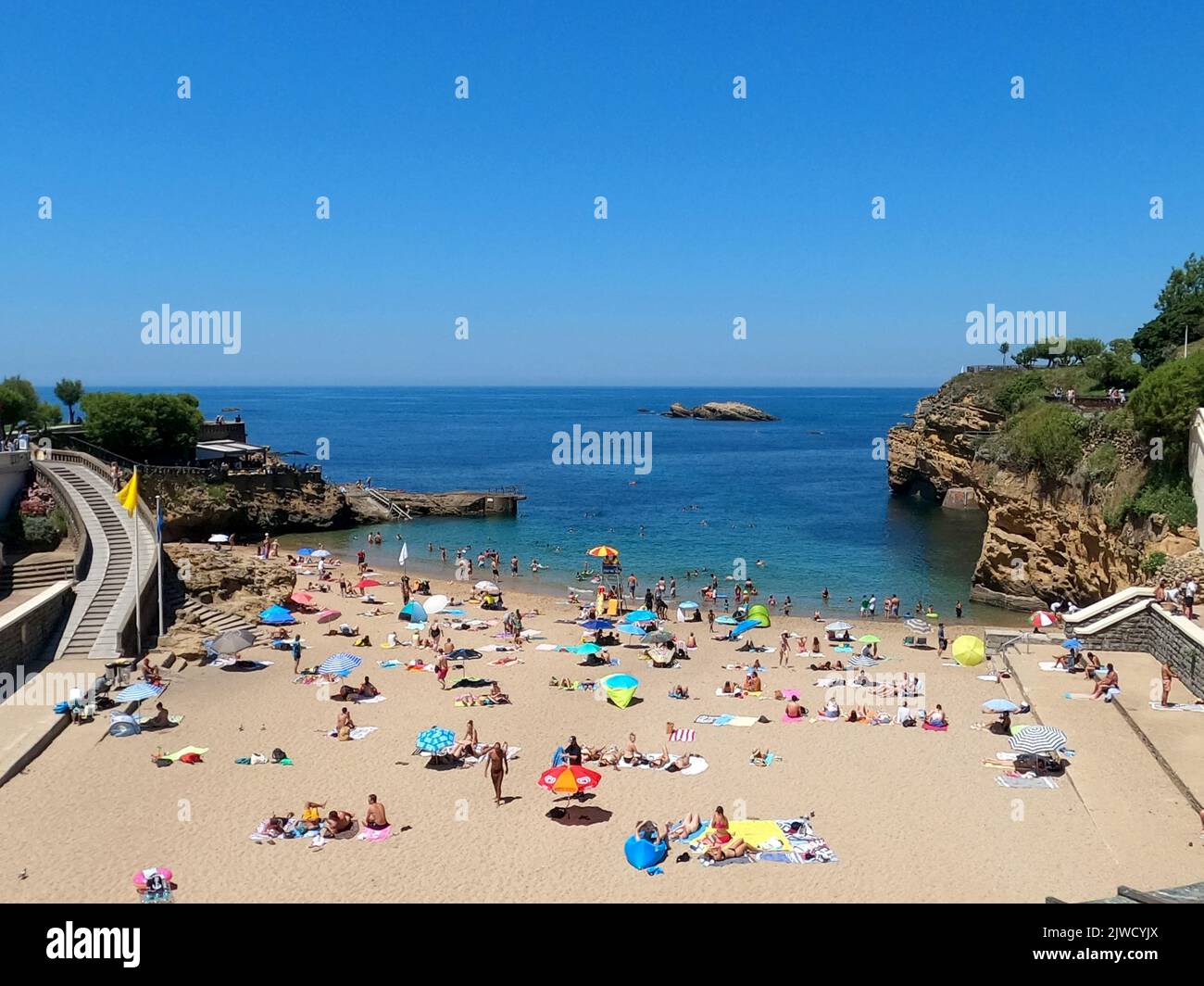 Biarritz, Atlantique Pyrenees. France: July 11, 2022: A view over the Plage du Port Vieux beach in Biarritz, France, with some people enjoying the bea Stock Photo