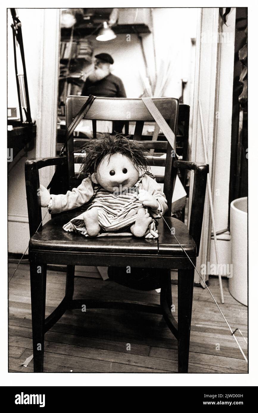 Inside the puppet building studio of Sesame Street's Kermit Love, seen in the mirror reflection. The puppet on the chair was built for a foreign country's version of Sesame Street. Stock Photo