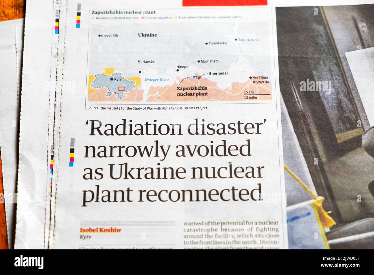 'Radiation disaster' narrowly avoided as Ukraine nuclear plant reconnected' Guardian newspaper headline energy article 27 August 2022 London UK Stock Photo
