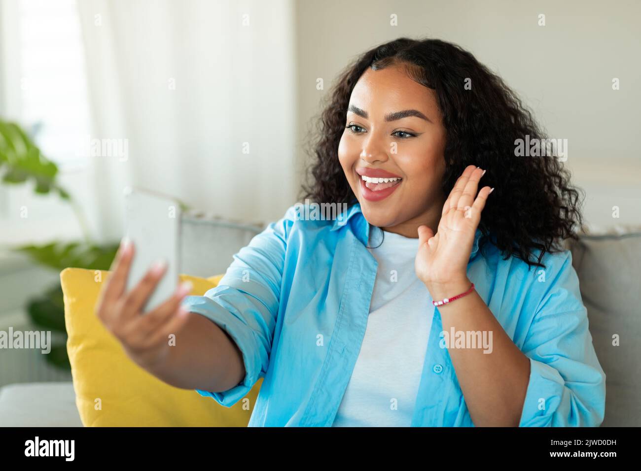 Happy Black Woman Making Video Call On Phone At Home Stock Photo - Alamy
