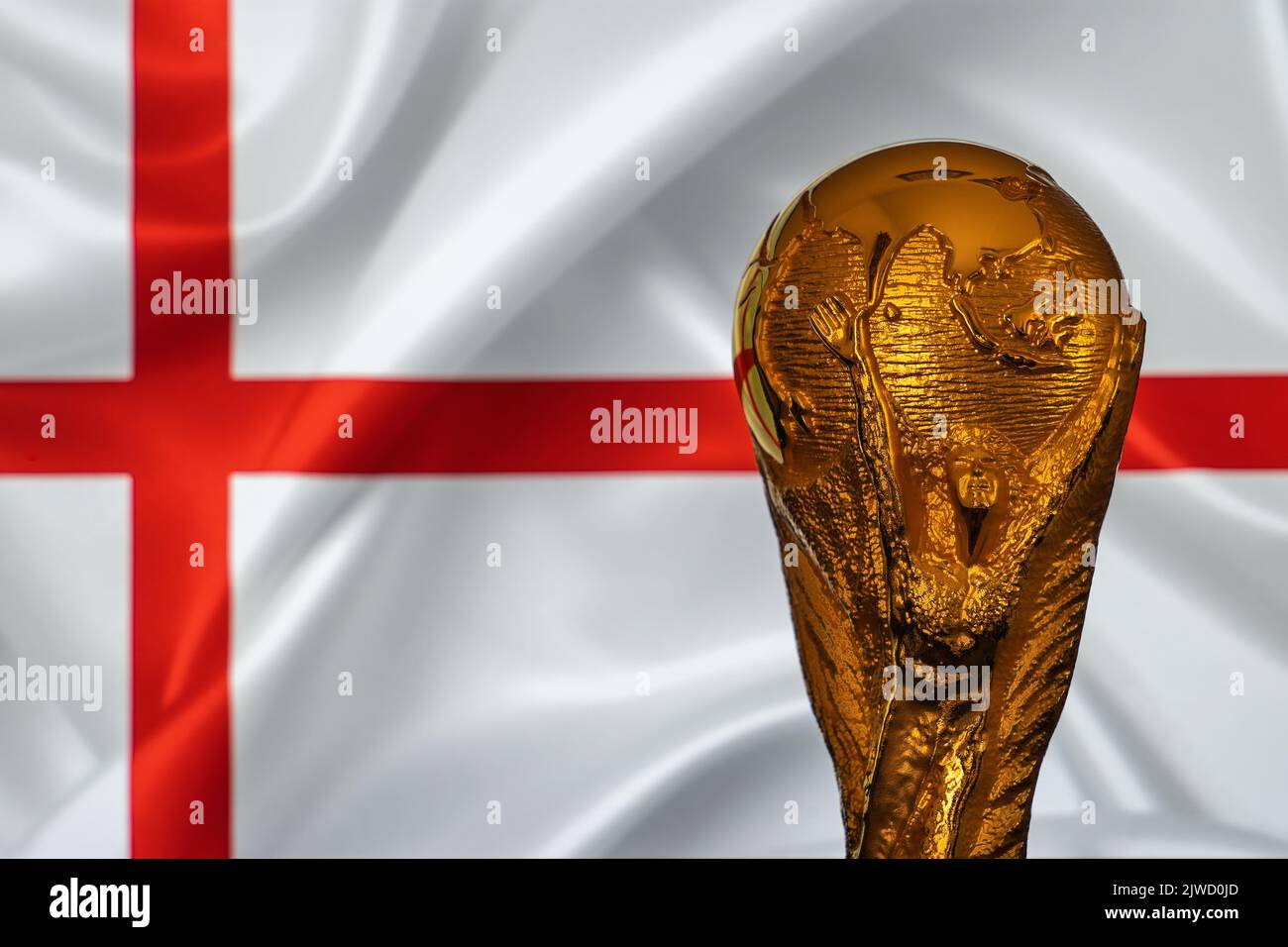 Doha, Qatar - September 4, 2022: FIFA World Cup trophy against the background of England flag. Stock Photo