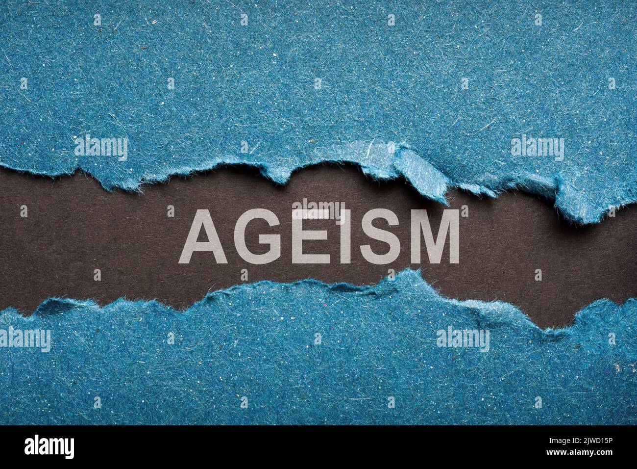 Black piece of paper with word Ageism. Stock Photo