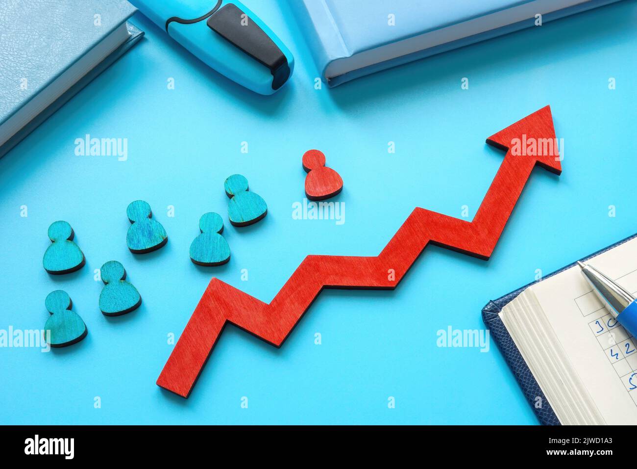 Pacesetting leadership concept. Red arrow, figurine as leader and blue ones. Stock Photo