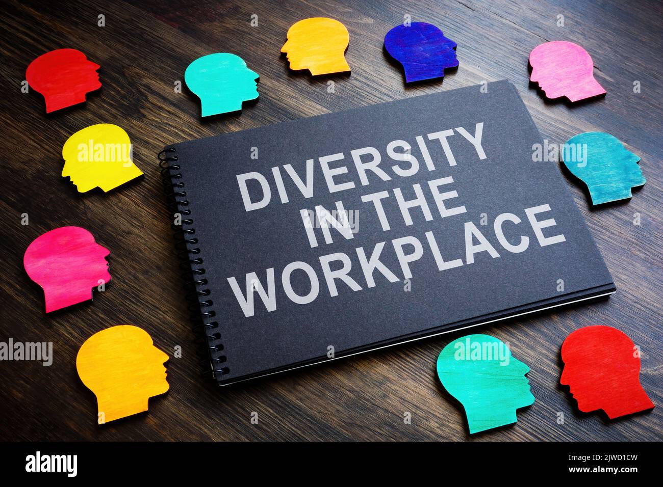Colored figures and an inscription Diversity in the workplace on a notebook. Stock Photo