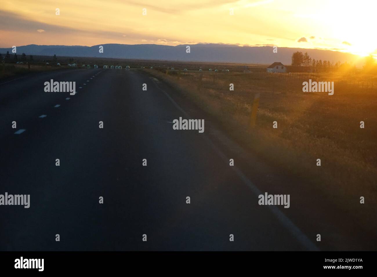 Driving a car in Iceland, sunset sky Stock Photo Alamy