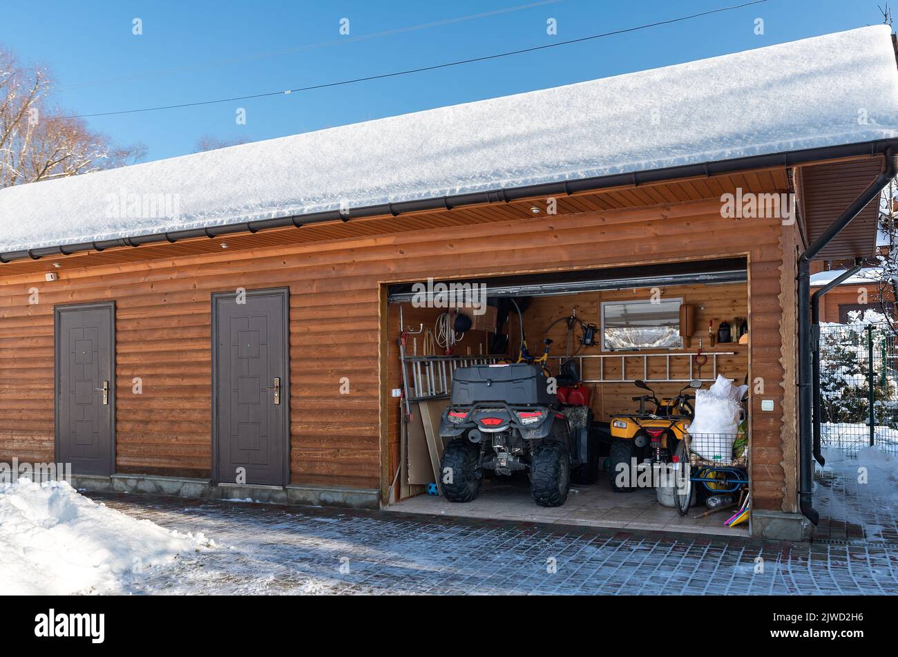 Facade view open door ATV home garage with quad bikes offroad vehicle