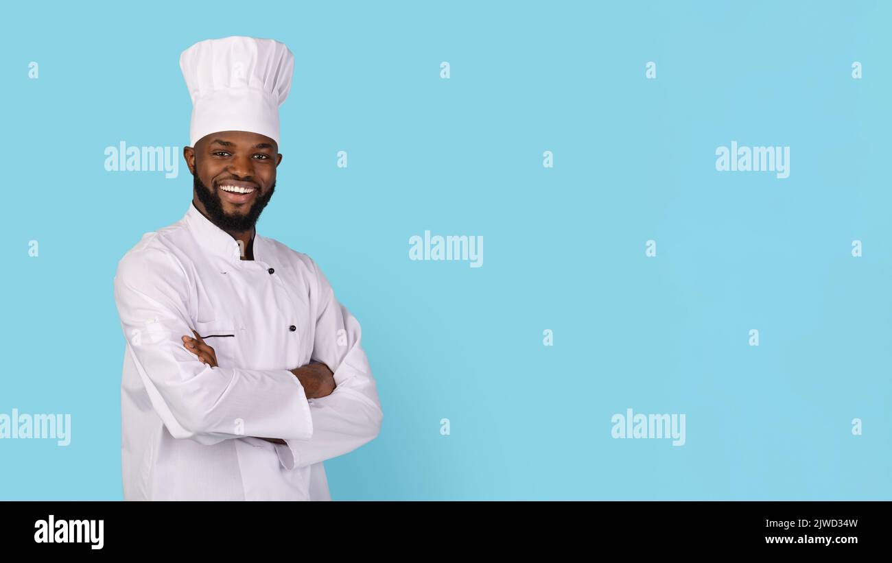 Portrait Of Smiling African American Chef Wearing Uniform Standing With Folded Arms Stock Photo
