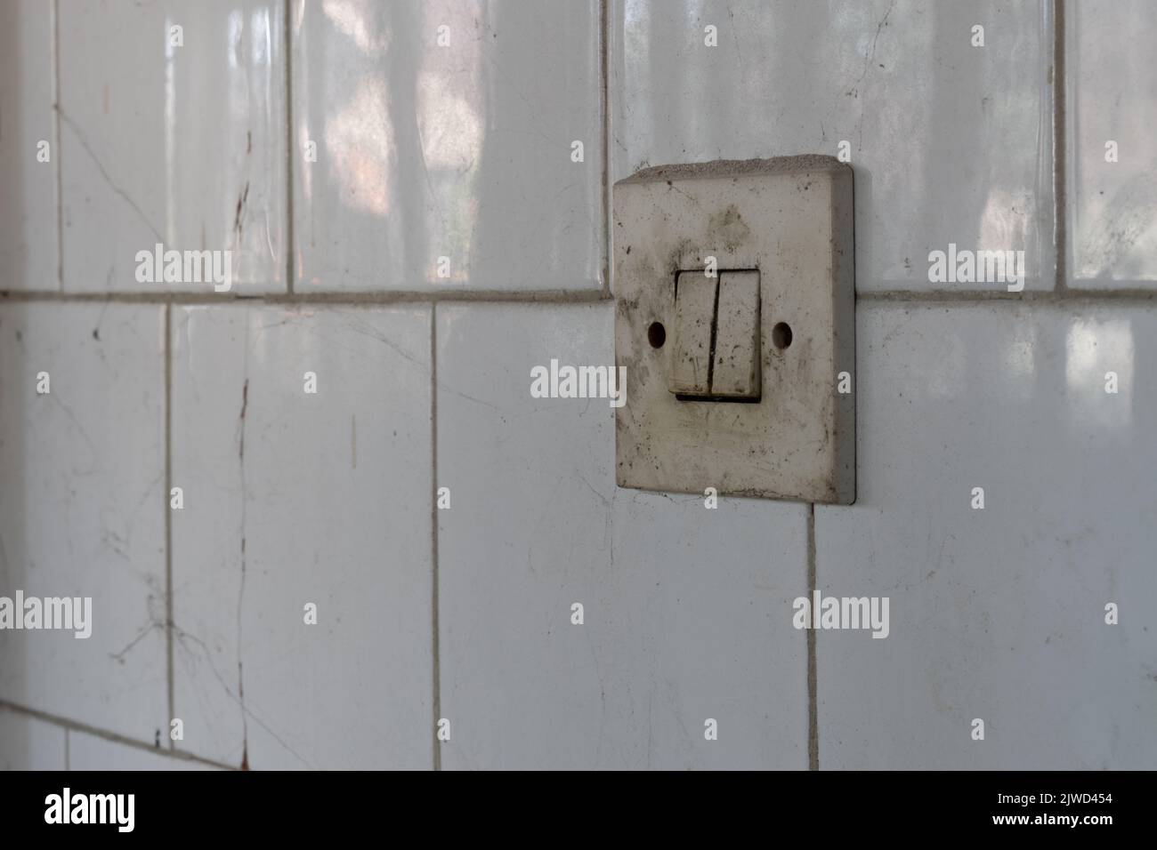 Dirty light switch on tiled wall close up, urban exploration Stock Photo Alamy