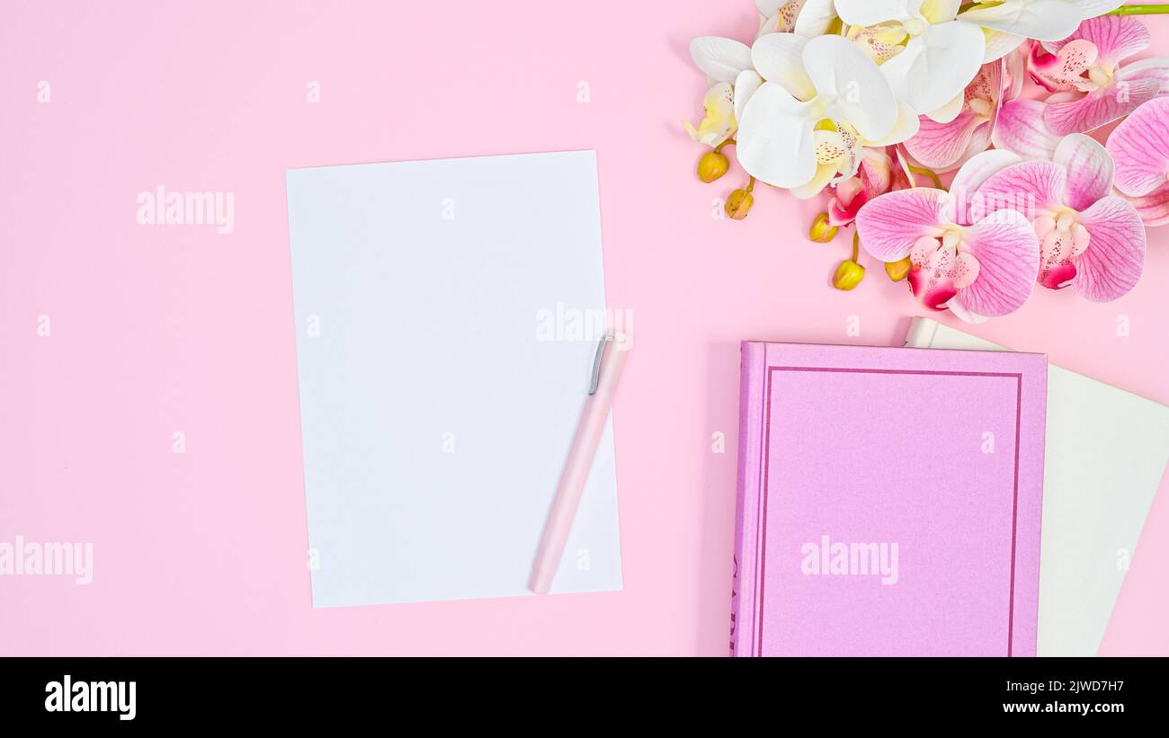 Romantic flat lay pastel pink background with books and notes and ...