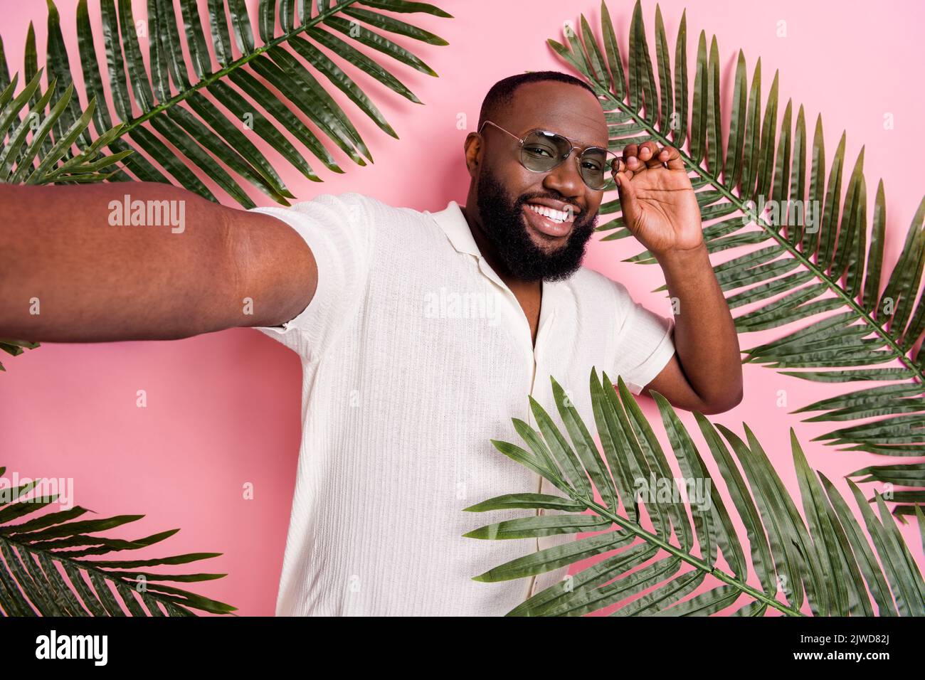 Portrait of cool cheerful person hand touch glasses take selfie isolated on pink color background Stock Photo