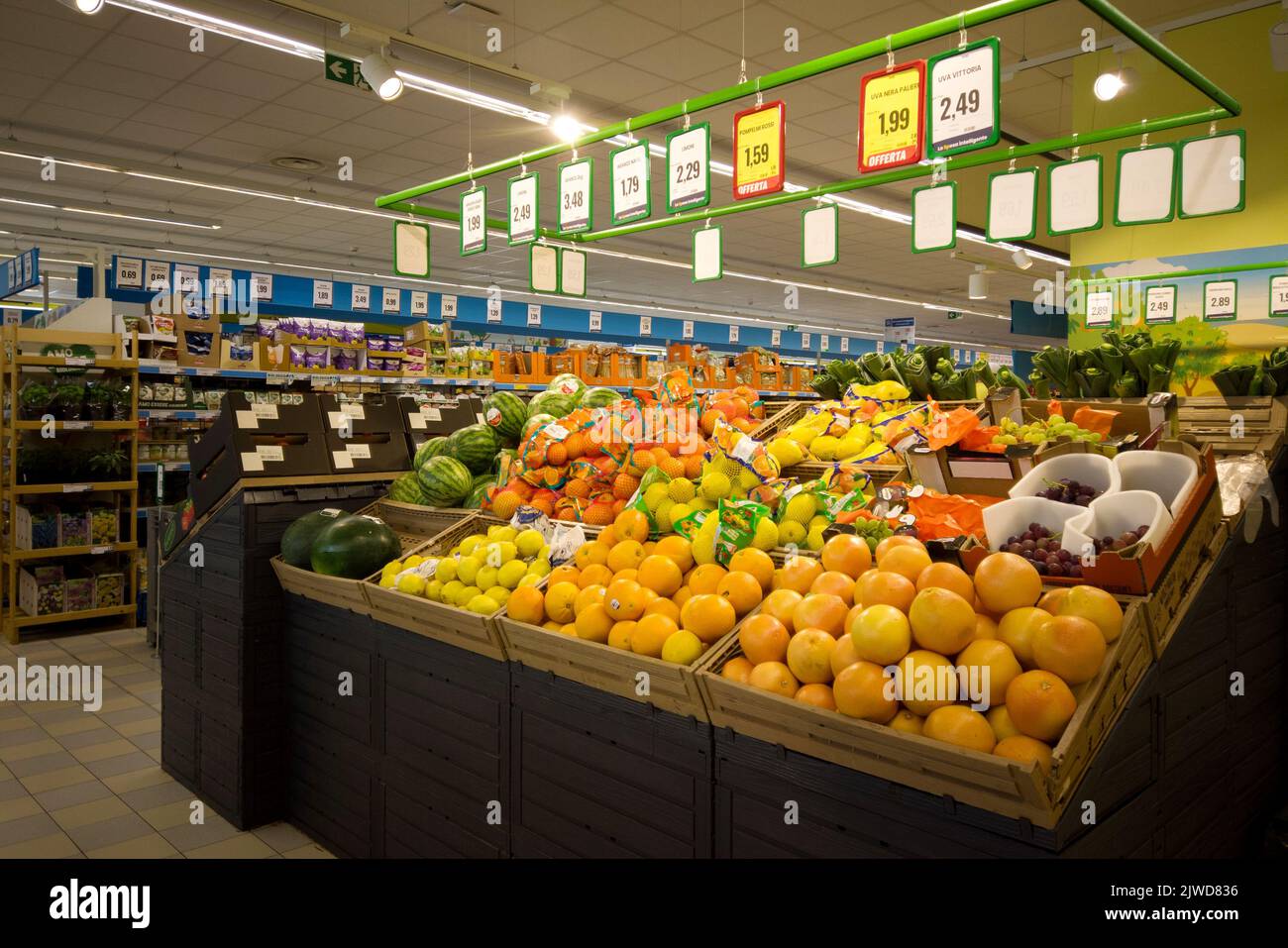 Fossano, Italy - August 30, 2022: stalls with fruit and vegetables in italian supermarket Eurospin, summer fruit in boxes displayed for sale with pric Stock Photo