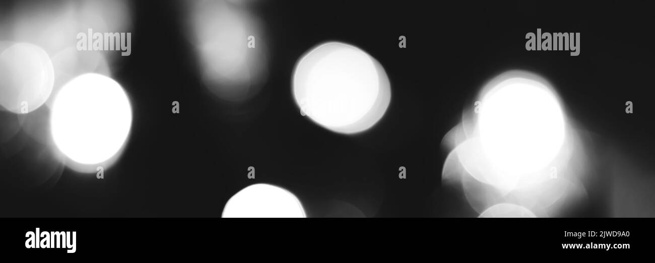 Blurred lights black and white background, banner texture. Abstract