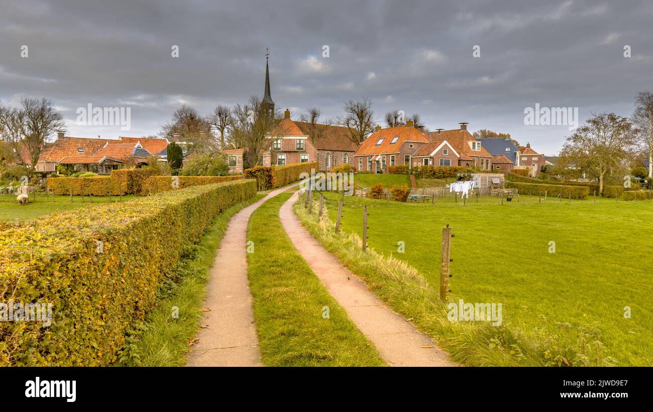 Neighborhood scene of street in hamlet of Niehove historic dwelling mound Village, Groningen Province, the Netherlands Stock Photo