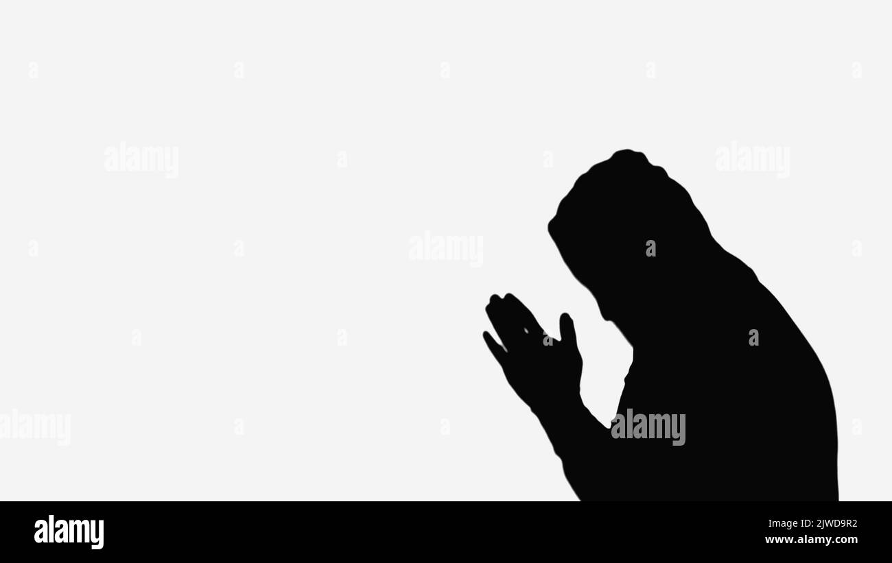 Silhouette man in hood praying hi-res stock photography and images - Alamy