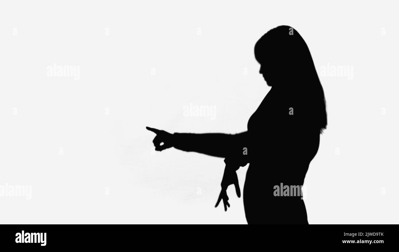 black shadow of woman pointing with finger isolated on white Stock Photo