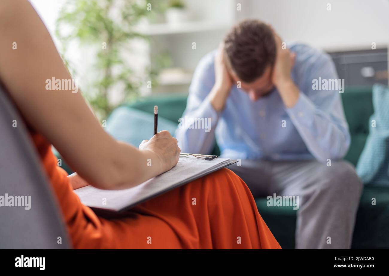 Stressed man at pschologist Stock Photo