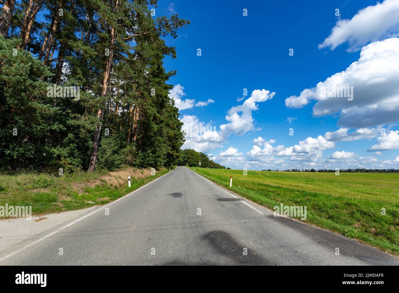 Road under blue sky with white clouds Stock Photo - Alamy