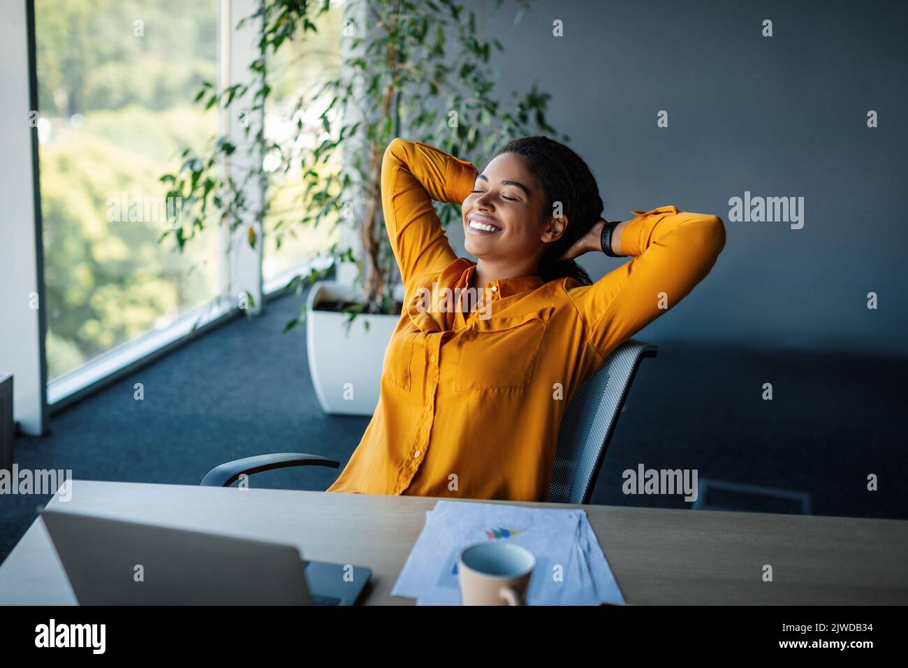 Taking break. Relaxed african american businesswoman resting on chair