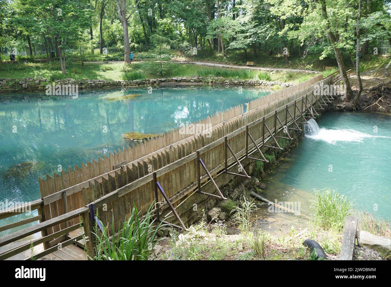 Beautiful blue water of a natural spring by a dam near Blue Spring Heritage Center, Eureka Springs, Arkansas, U.S.A Stock Photo