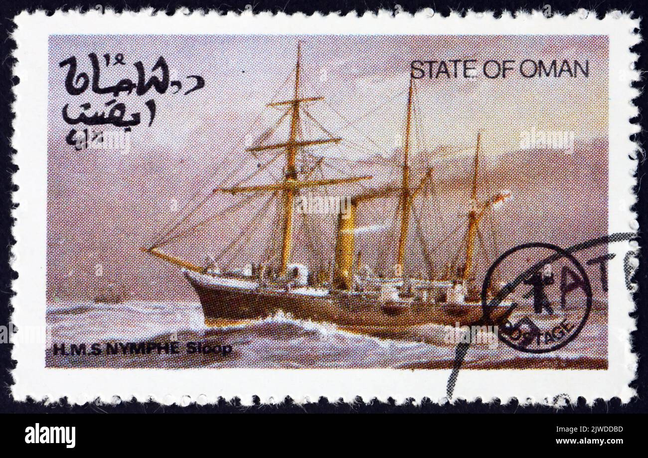 OMAN - CIRCA 1977: a stamp printed in State of Oman shows HMS Nymphe, was a Nymphe-class composite screw sloop, built for the Royal Navy between 1885 Stock Photo