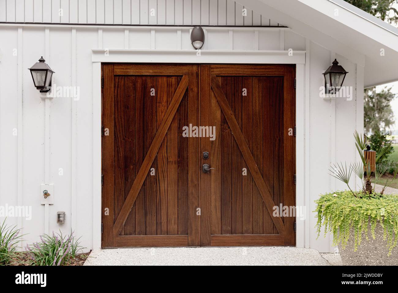 a large set of stained dark wood garage door on a public building Stock