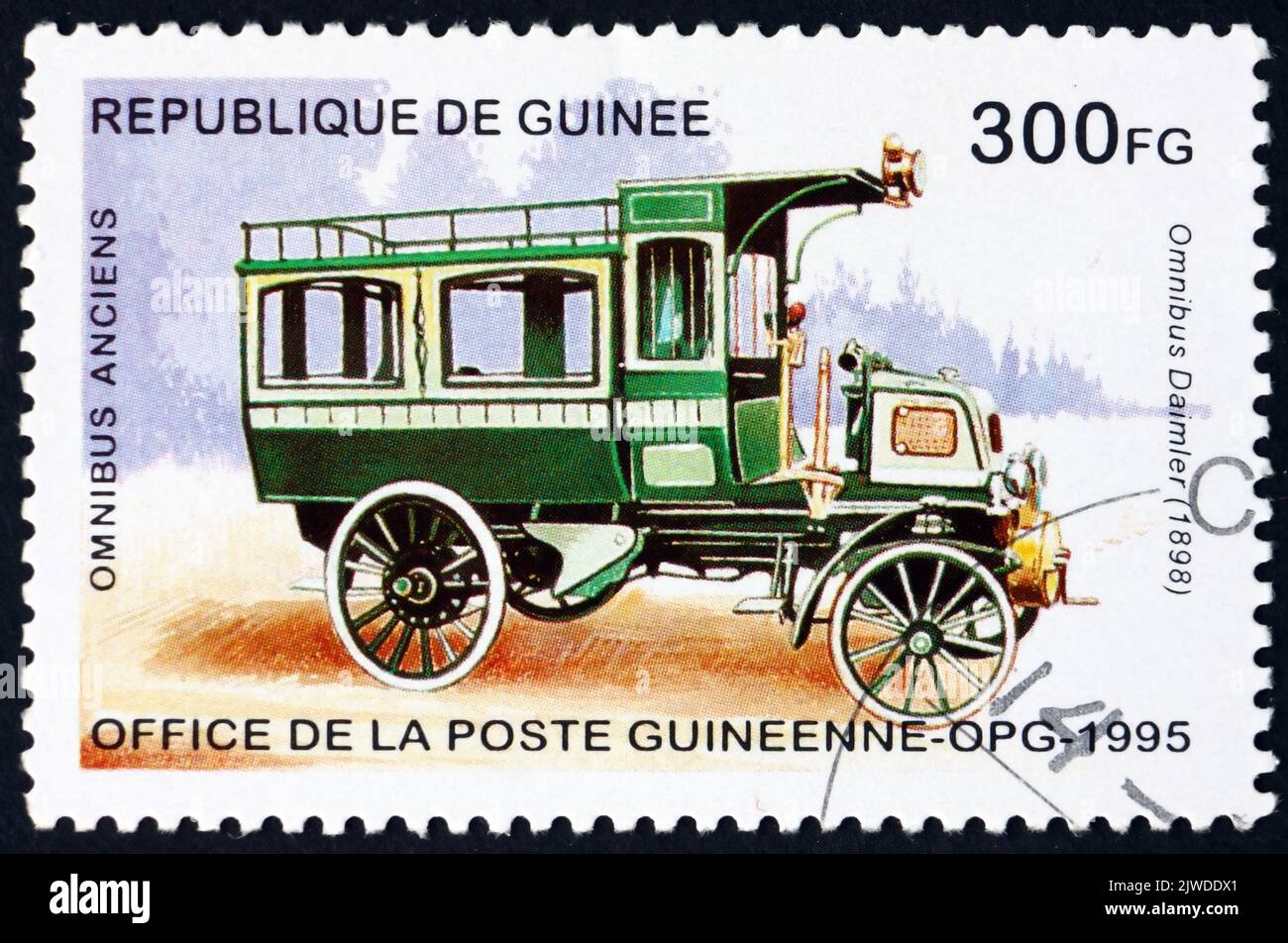GUINEA - CIRCA 1995: a stamp printed in Guinea shows 1898 Daimler, historic bus, circa 1995 Stock Photo
