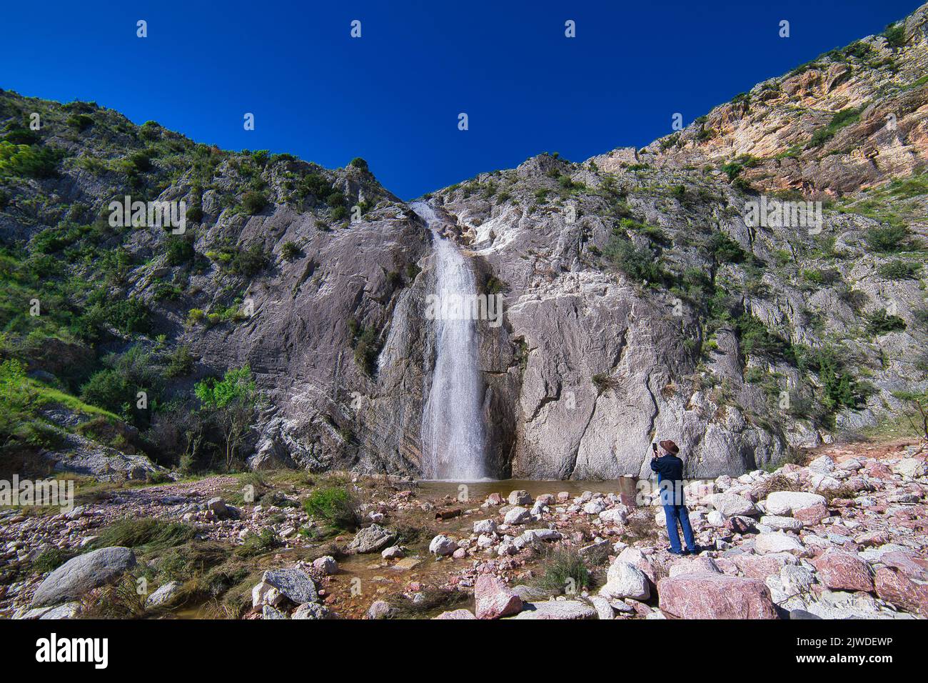 A beautiful waterfall streaming down to a small pond Stock Photo - Alamy