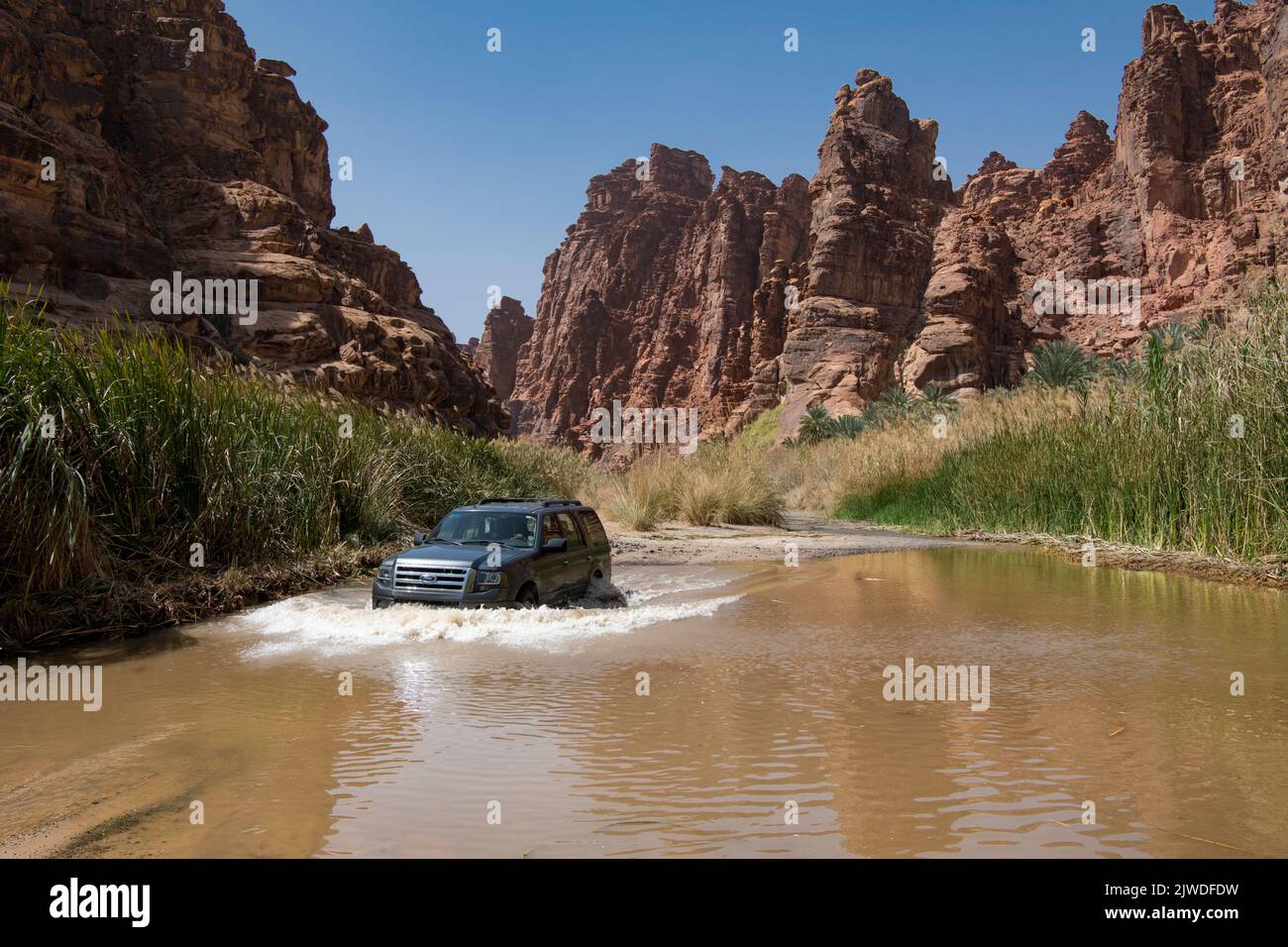 4WD crossing flooded track Wadi Disah Tabuk Province Saudi Arabia Stock Photo