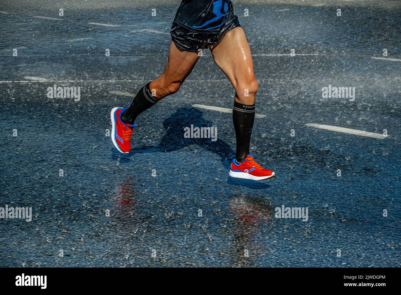 Ekaterinburg, Russia - August 7, 2022: legs runner athlete run summer rain in Europe-Asia Marathon Stock Photo