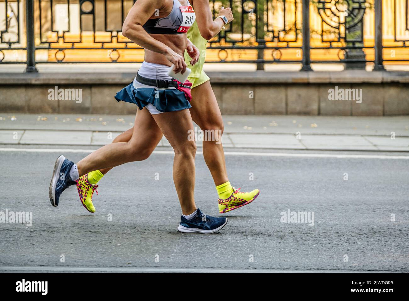 Ekaterinburg, Russia - August 7, 2022: legs two female runners run in Europe-Asia Marathon Stock Photo