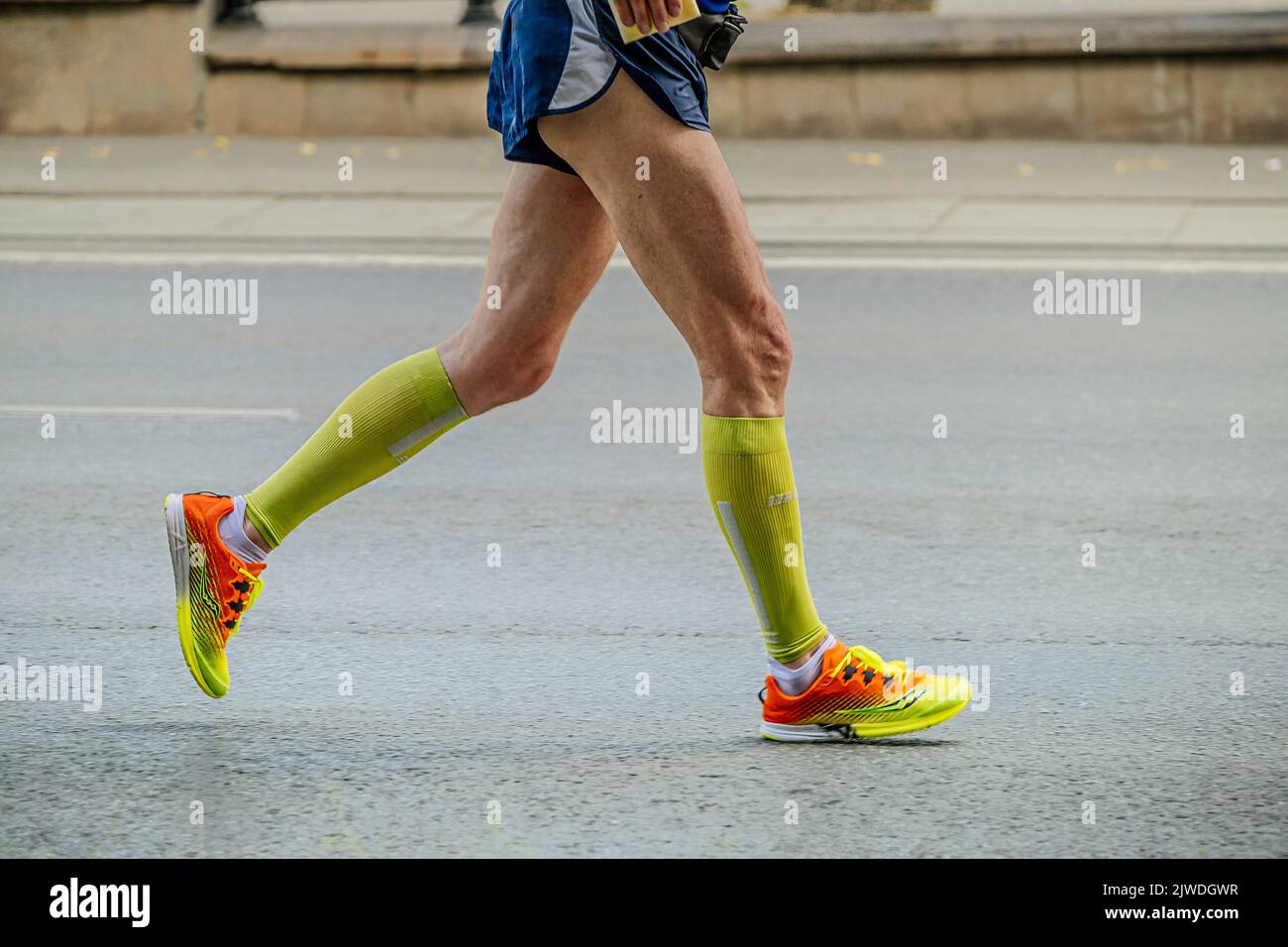 Ekaterinburg, Russia - August 7, 2022: male runner legs in compression socks run in Europe-Asia Marathon Stock Photo