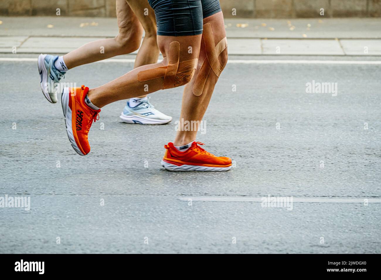 Ekaterinburg, Russia - August 7, 2022: legs male and female runners athletes running in Europe-Asia Marathon Stock Photo