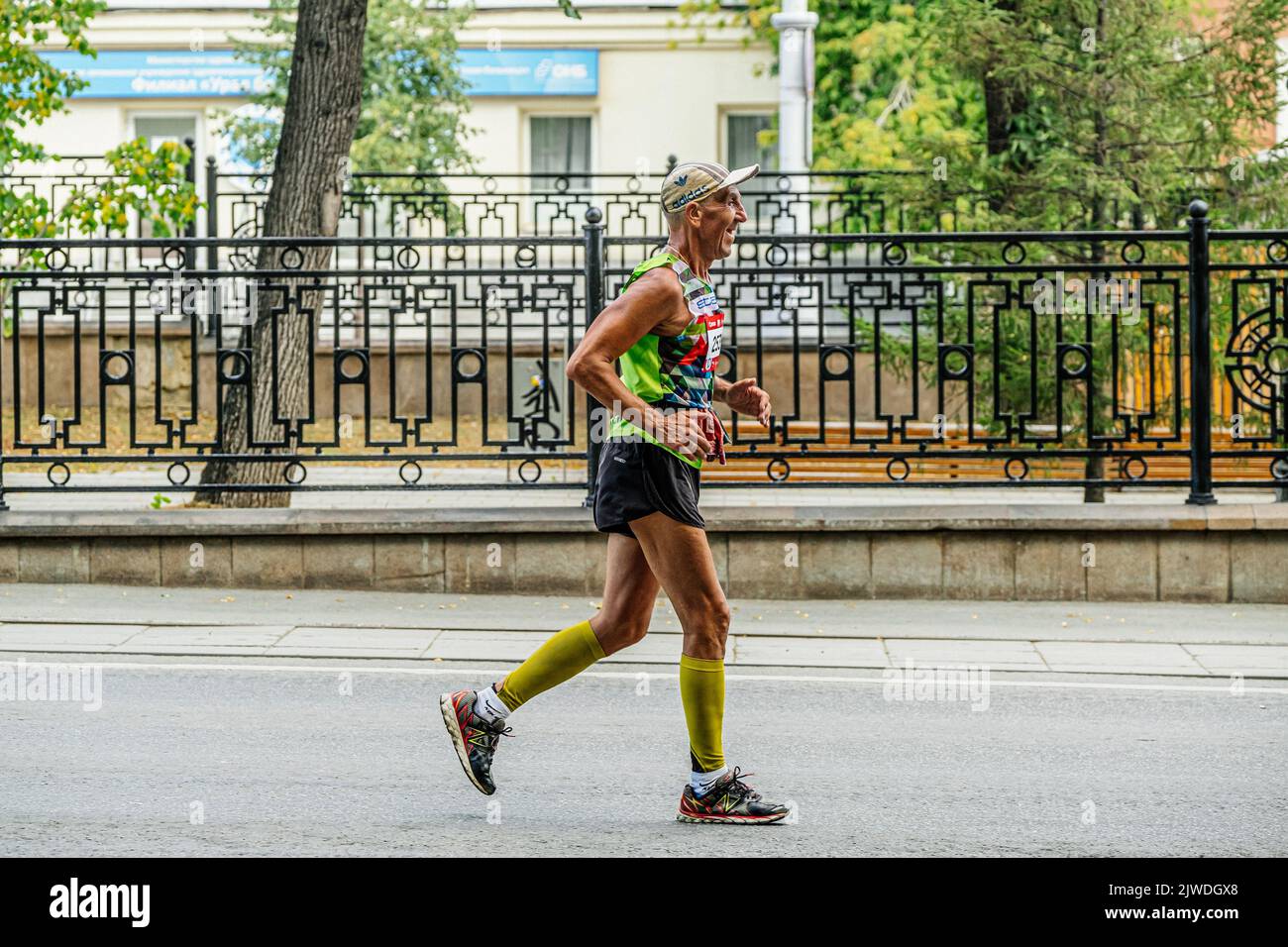 Ekaterinburg, Russia - August 7, 2022: elderly male runner run half marathon in Europe-Asia Marathon Stock Photo