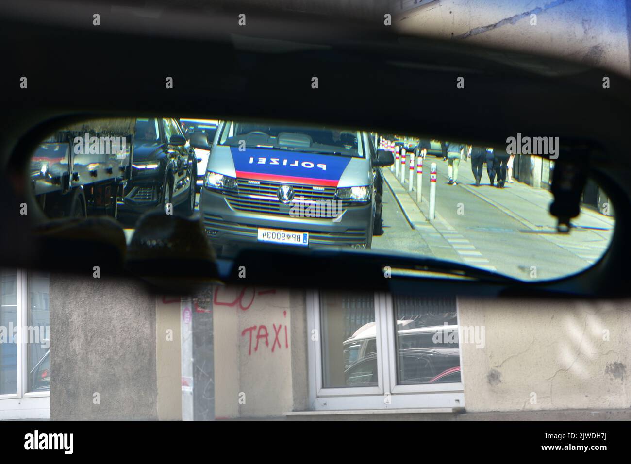 A police car in the rear view mirror in a traffic jam at a traffic