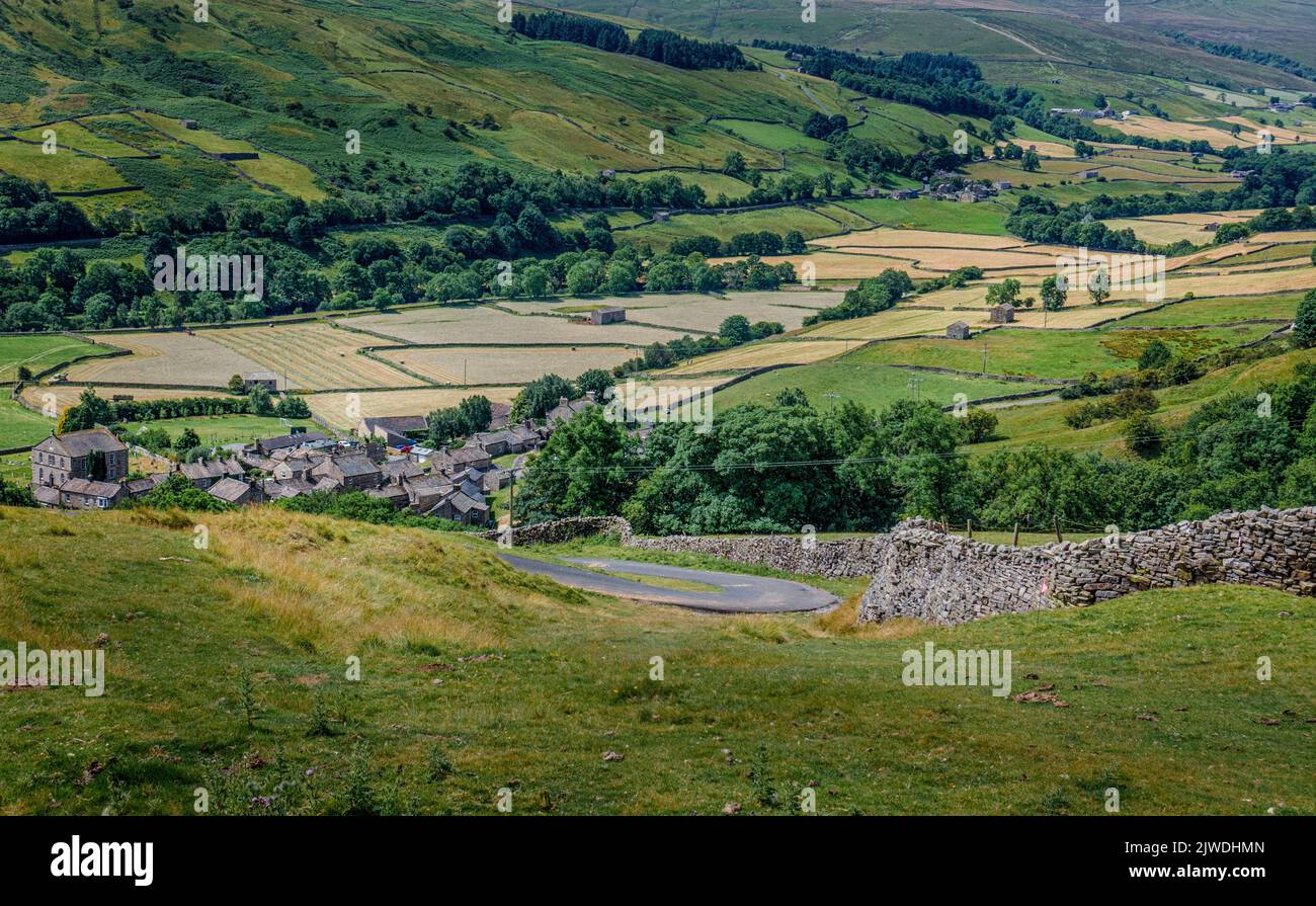 View from near the top of Electric Gate Climb which is a steep hill climb looking at Gunnerside village in Swaledale, Yorkshire Dales National Park, E Stock Photo