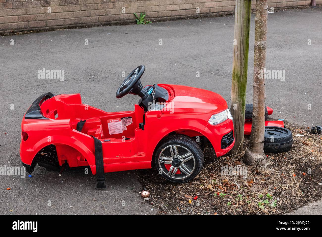 Car crash with child's electric car colliding with a tree in Wales UK Stock Photo