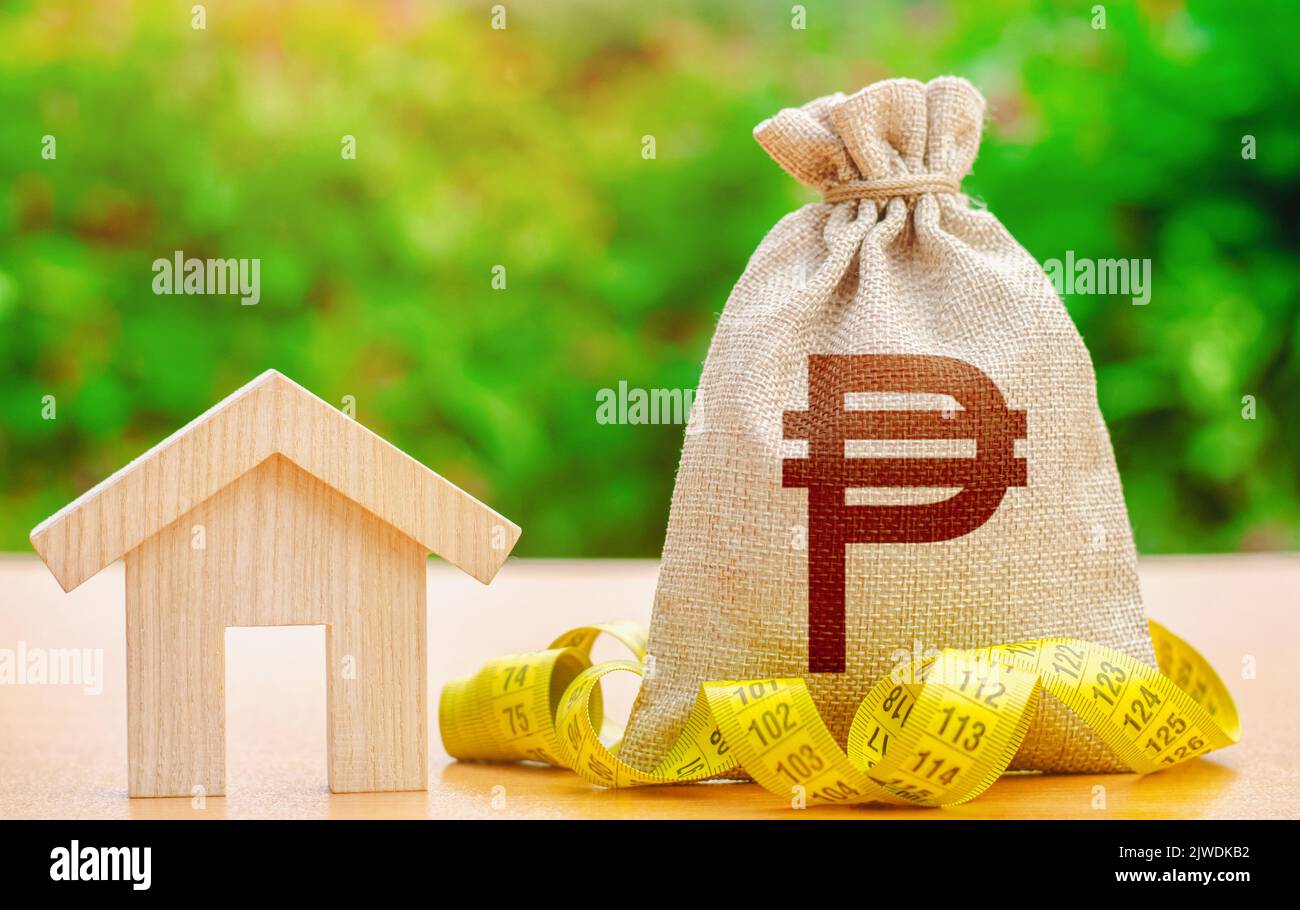 House and philippine peso money bag. Real estate appraisal. Property valuation. Building maintenance. Mortgage loan calculation. Budgeting. Cost of ho Stock Photo