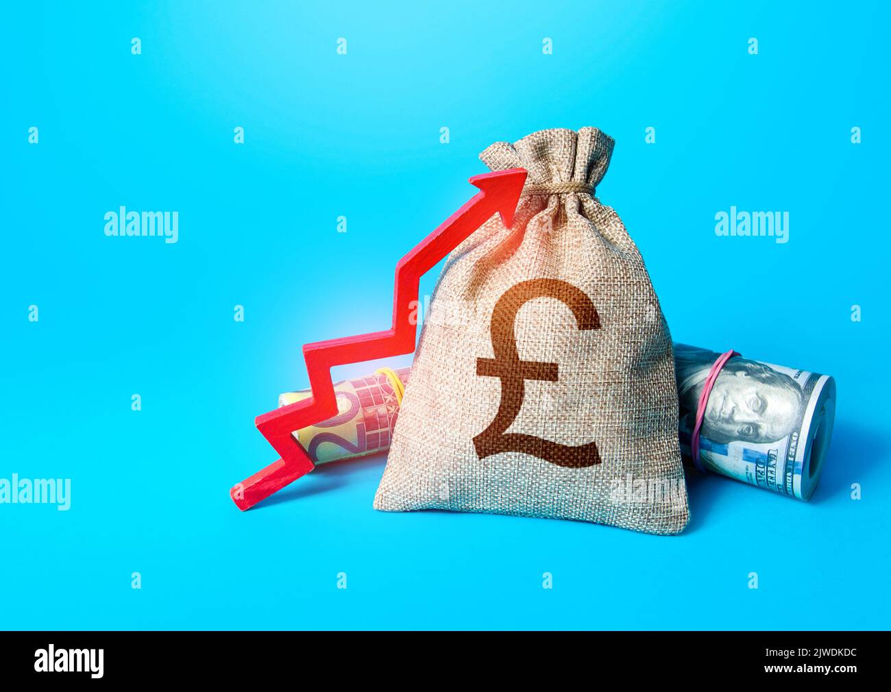 British pound sterling money bag and red up arrow. Rise in profits. Increase in the deposit rate. Increase income and business efficiency. Inflation a Stock Photo