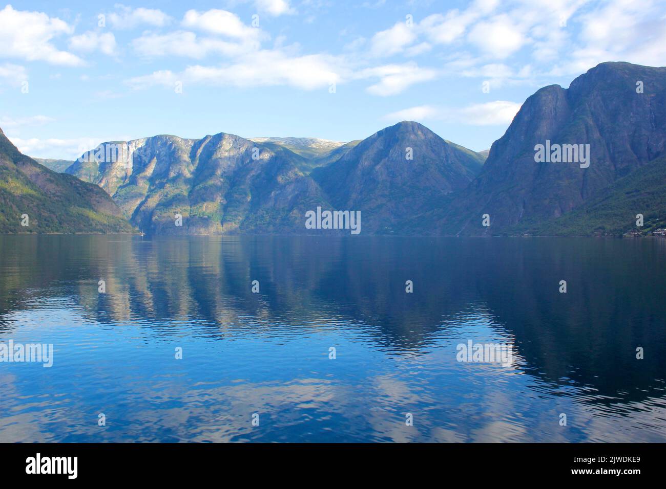 A view across the water to the peaks of Aurlandsfjord from Aurland on the ferry from Flam Stock Photo