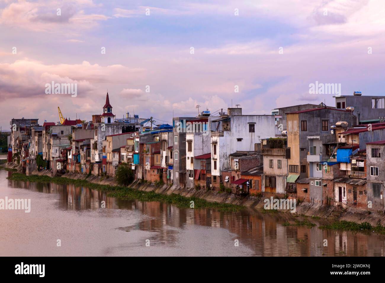 Houses along Cam River, Hai Phong, Vietnam at sunset Stock Photo
