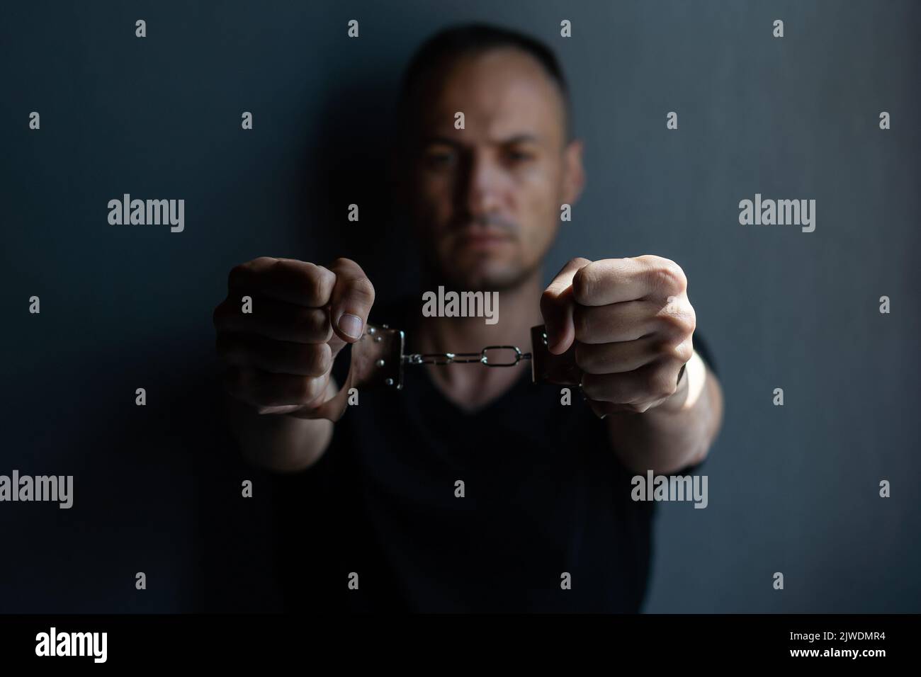 prisoner concept, Handcuffed hands of a prisoner in prison, Male prisoners were severely strained in the dark prison, violence, Stock Photo