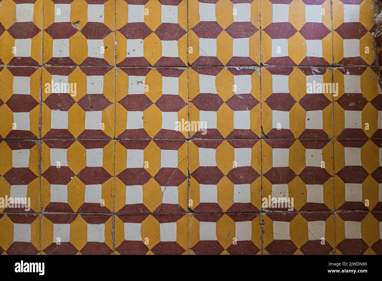 Tiled floor with a yellow and red pattern background Stock Photo - Alamy