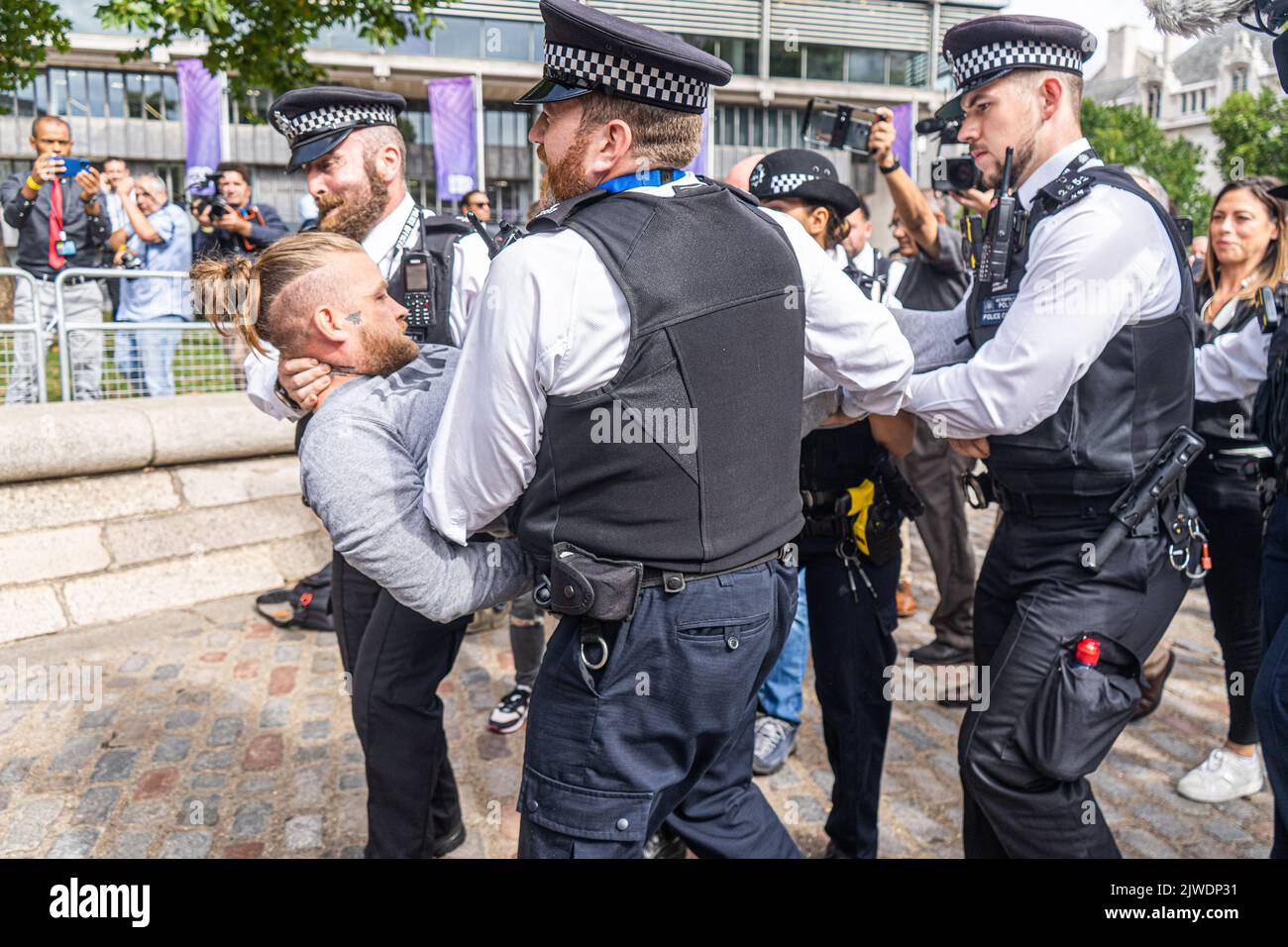 London UK. 5 September 2022.  An animal rebellion protesters is carried away by polic officers after  staging a sit in blocking the road opposite the Queen Elizabeth II centre  as   Liz Truss is due to be elected as the new Conservative party leader and prime minister a Credit amer ghazzal/Alamy Live News Stock Photo