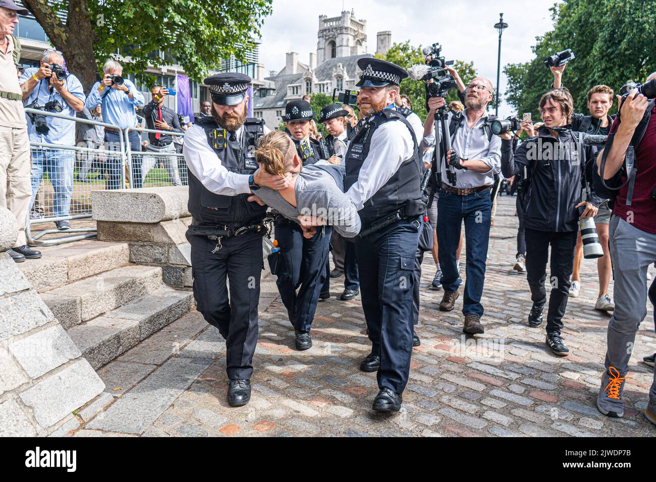 London UK. 5 September 2022.  An animal rebellion protester is carried away by police officers after staging a sit and blocking the road opposite the Queen Elizabeth II centre before   Liz Truss is announced as the new Conservative party leader and prime minister elect. Credit amer ghazzal/Alamy Live News Stock Photo